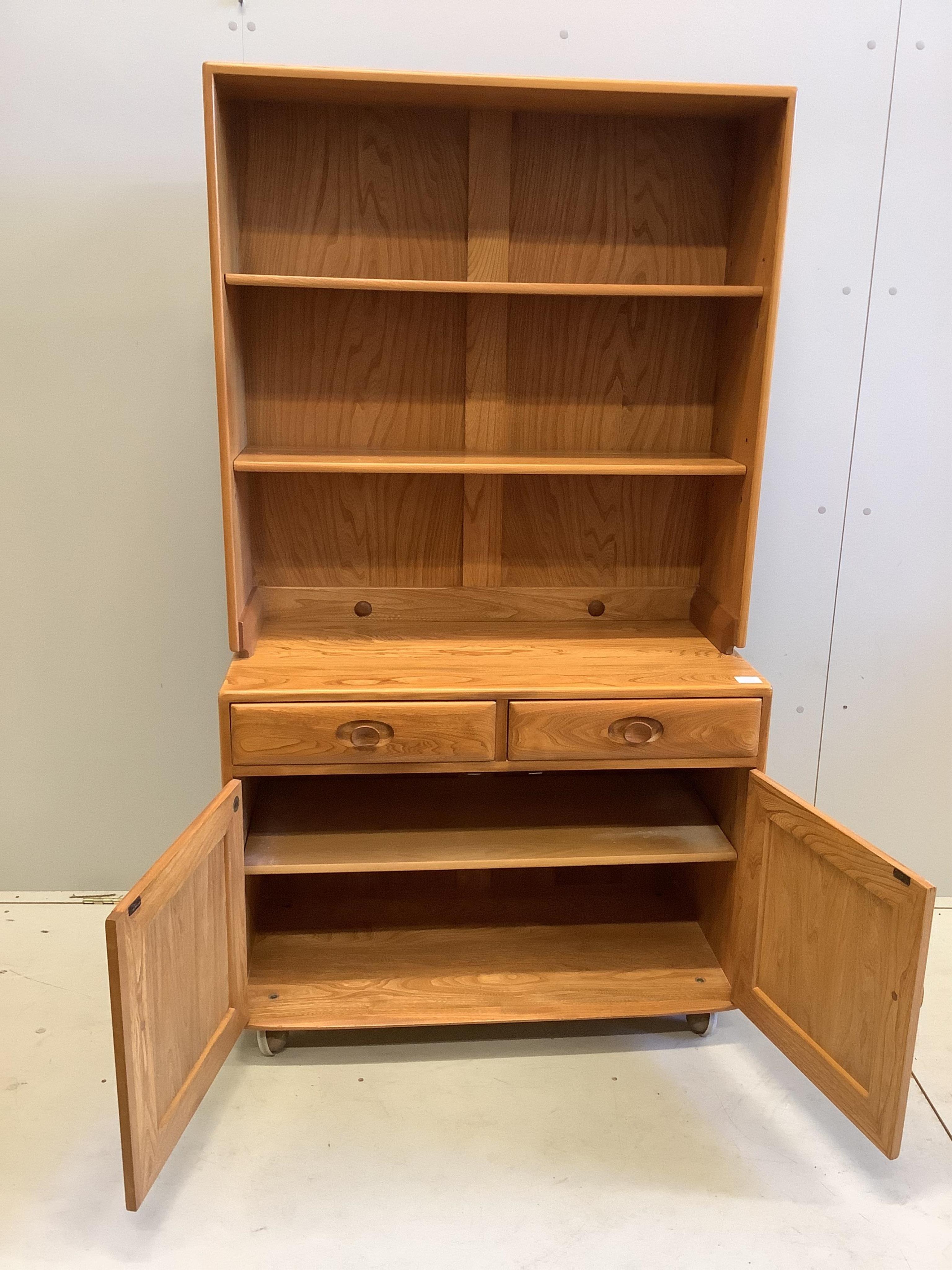 An Ercol Windsor elm side cabinet, width 91cm, depth 43cm, height 160cm. Condition - good